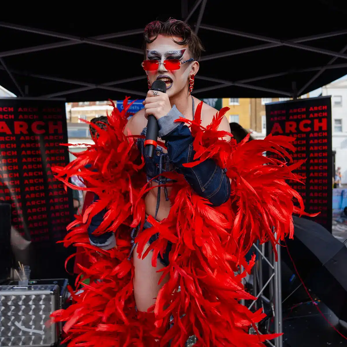 Crowds celebrating Clapham Pride at Arch Clapham street party with drag performers, DJs, dancing and a lively LGBTQ+ atmosphere on Voltaire Road.