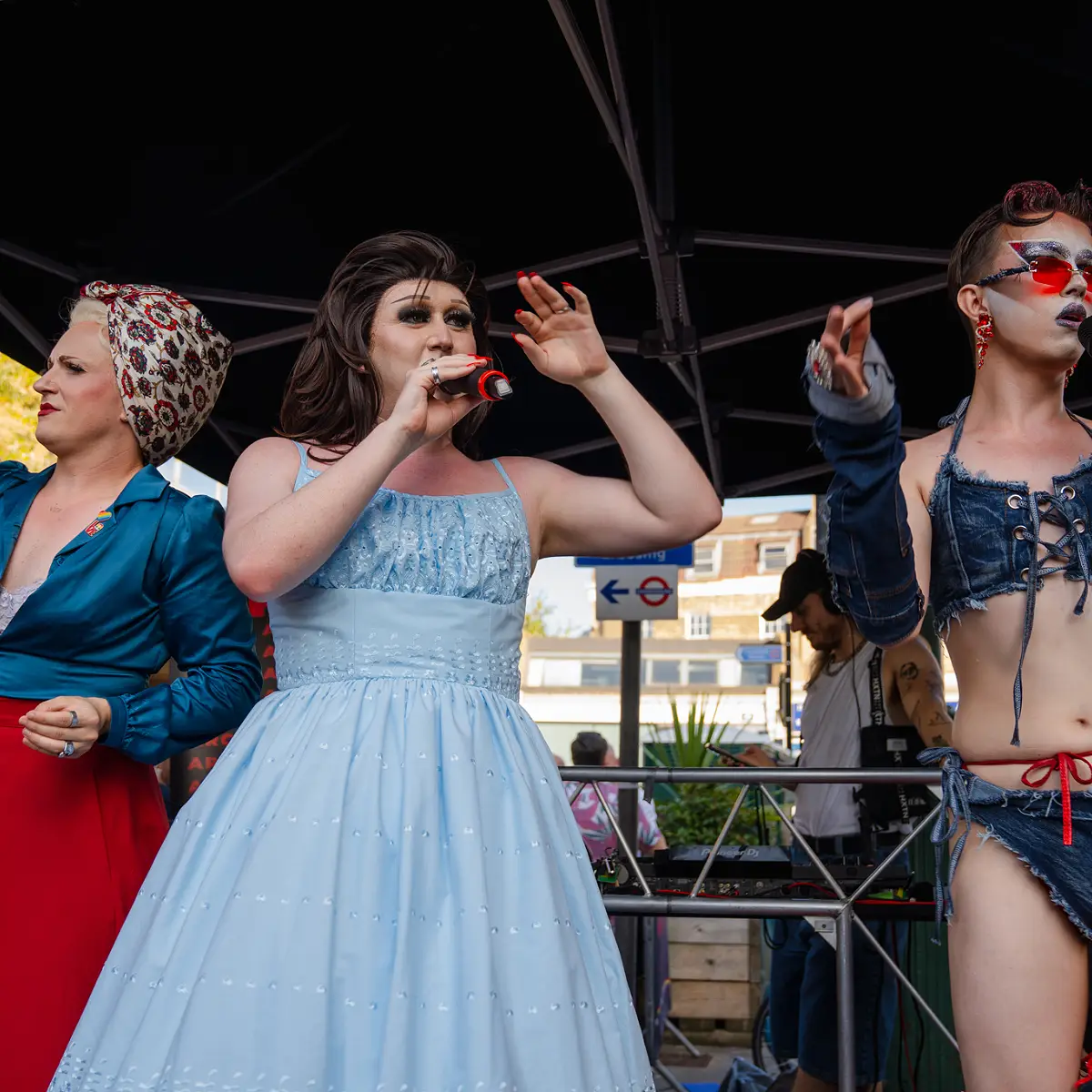 Crowds celebrating Clapham Pride at Arch Clapham street party with drag performers, DJs, dancing and a lively LGBTQ+ atmosphere on Voltaire Road.