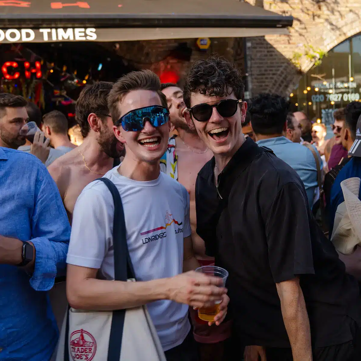 Crowds celebrating Clapham Pride at Arch Clapham street party with drag performers, DJs, dancing and a lively LGBTQ+ atmosphere on Voltaire Road.