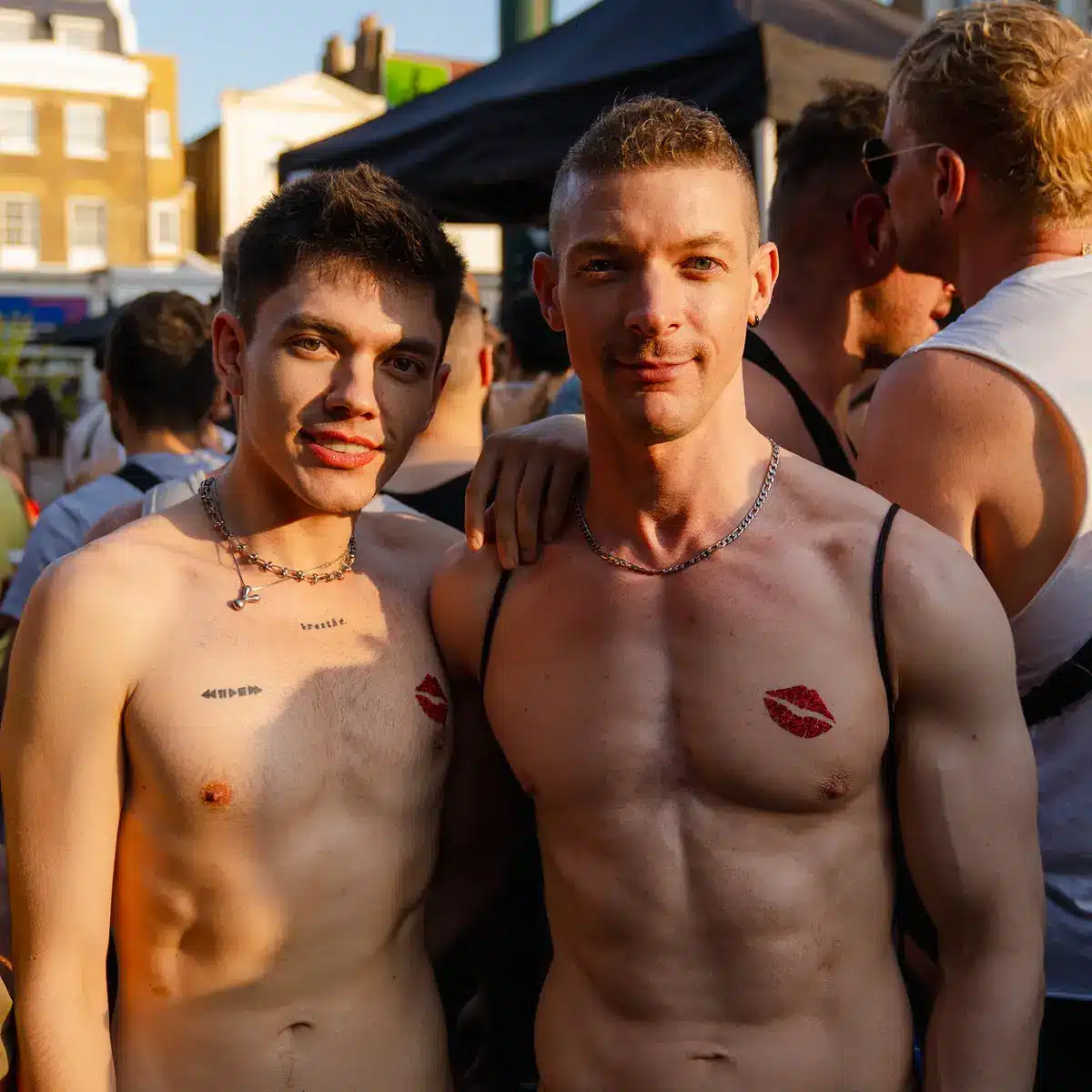 Crowds celebrating Clapham Pride at Arch Clapham street party with drag performers, DJs, dancing and a lively LGBTQ+ atmosphere on Voltaire Road.