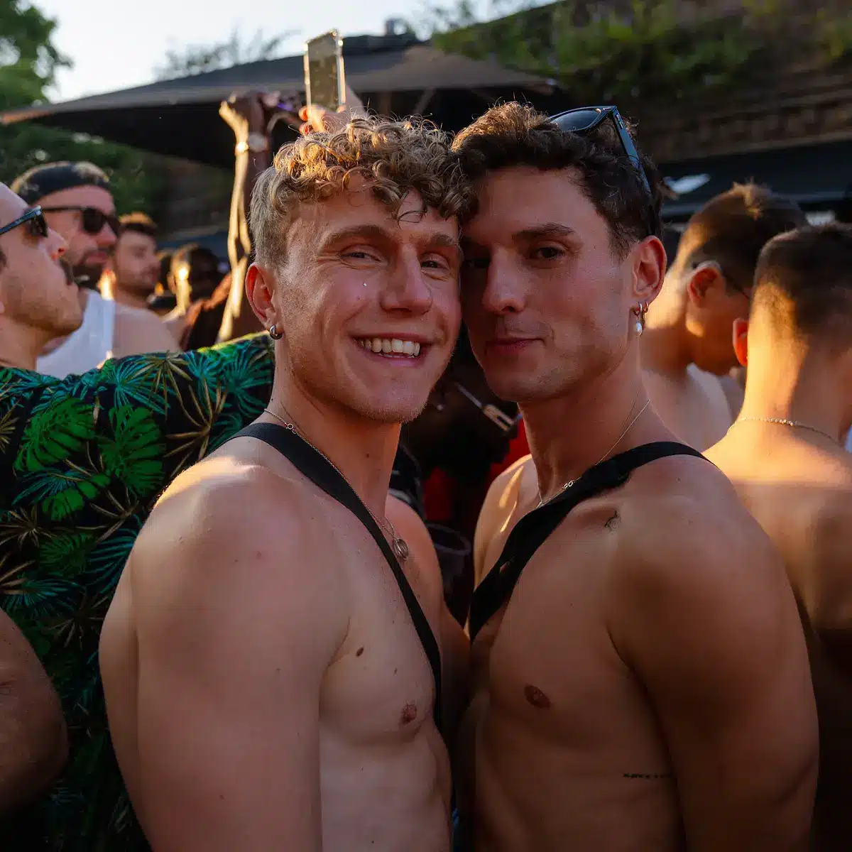 Crowds celebrating Clapham Pride at Arch Clapham street party with drag performers, DJs, dancing and a lively LGBTQ+ atmosphere on Voltaire Road.