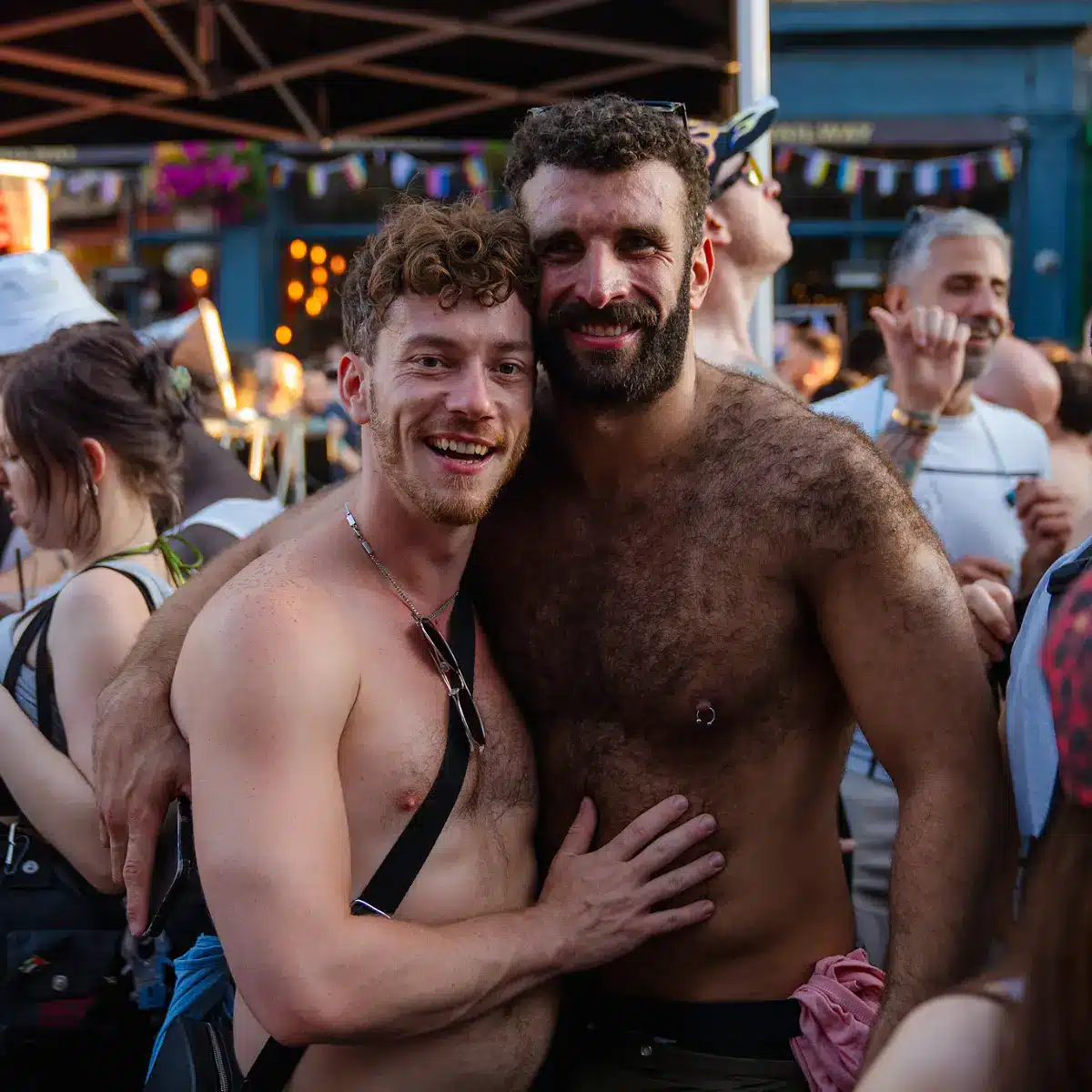 Crowds celebrating Clapham Pride at Arch Clapham street party with drag performers, DJs, dancing and a lively LGBTQ+ atmosphere on Voltaire Road.